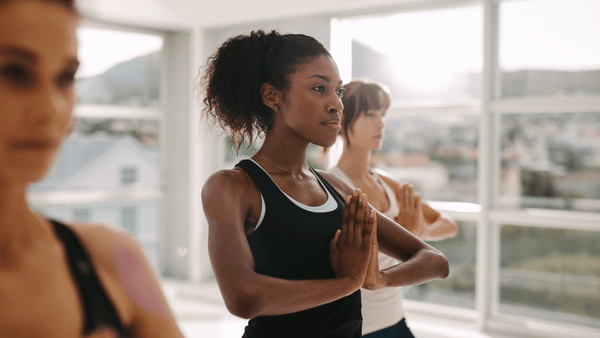 three women during yoga session in a studio